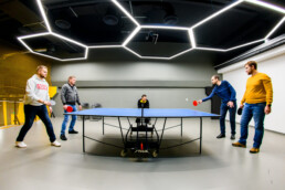 levi9 team playing table tennis in gaming room